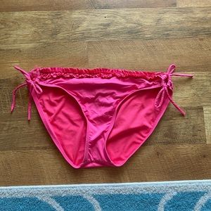 Pink swimsuit bottoms. Has where you can tie on the side and ruffles on top